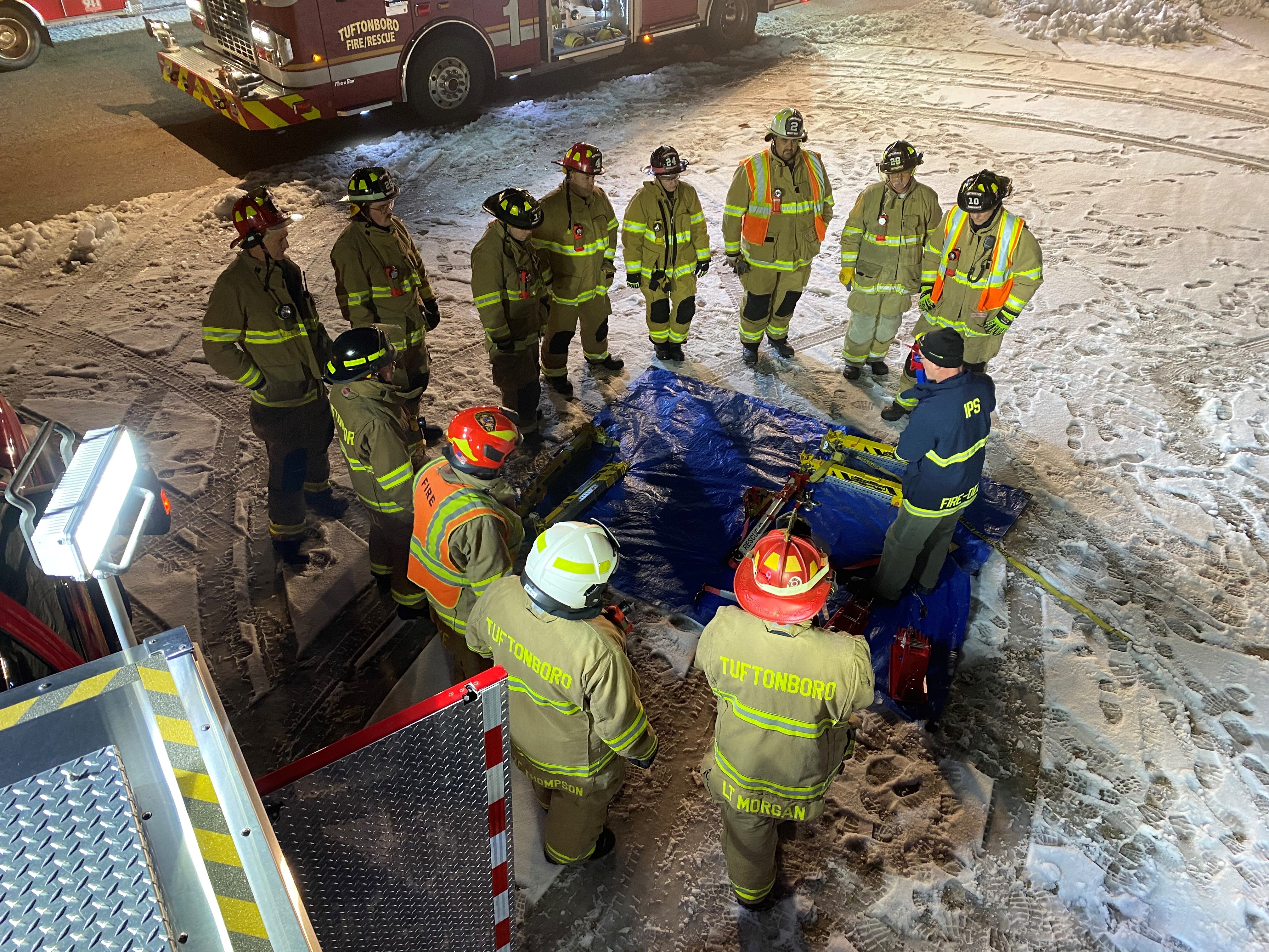 Group of firefighters standing in circle during briefing
